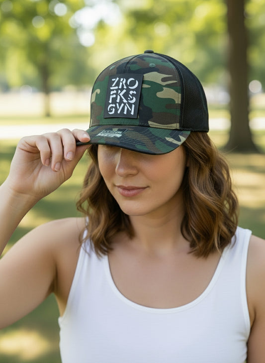 Camouflage cap with branding on a wooden surface